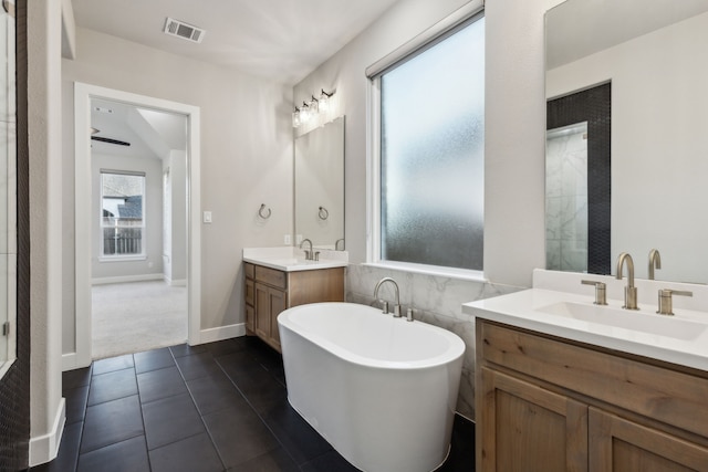 2921 Citation Rd, Celina, TX 75009 - full bath with a freestanding bath, two vanities, and tile patterned floors