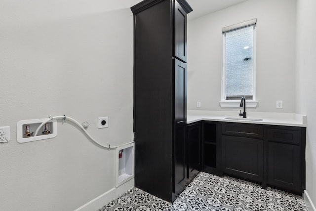 2921 Citation Rd, Celina, TX 75009 - laundry room with electric dryer hookup, cabinet space, light tile patterned floors, baseboards, and gas dryer hookup