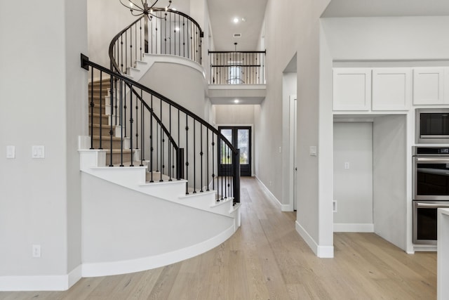 2921 Citation Rd, Celina, TX 75009 - foyer entrance featuring stairs, light wood-style floors, a high ceiling, baseboards, and a chandelier
