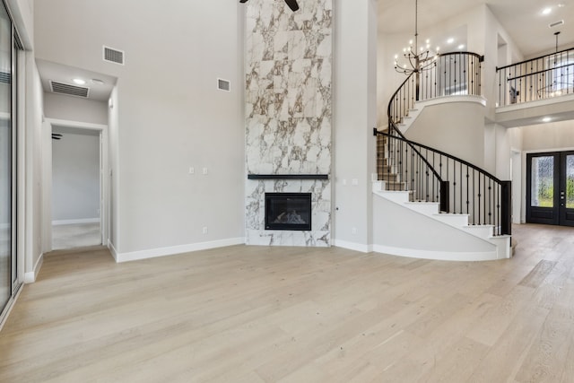 2921 Citation Rd, Celina, TX 75009 - unfurnished living room with a towering ceiling, stairs, wood finished floors, a fireplace, and baseboards