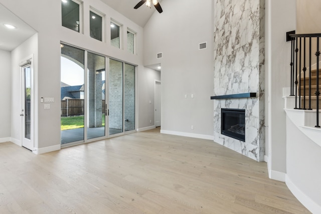2921 Citation Rd, Celina, TX 75009 - unfurnished living room with a ceiling fan, a premium fireplace, wood finished floors, baseboards, and a high ceiling