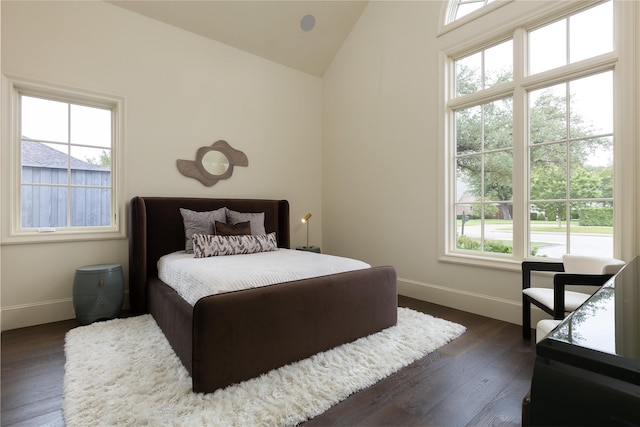5610 Lobello, Dallas, TX 75229 - bedroom featuring multiple windows, baseboards, lofted ceiling, and dark wood-type flooring