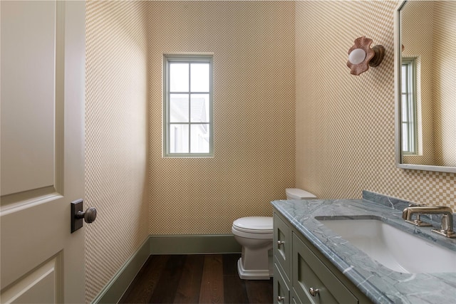 5610 Lobello, Dallas, TX 75229 - half bathroom featuring wood finished floors, toilet, and vanity