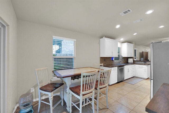 5061 Britton Ridge Ln, Fort Worth, TX 76179 - kitchen featuring appliances with stainless steel finishes, a sink, tasteful backsplash, white cabinets, and dark countertops