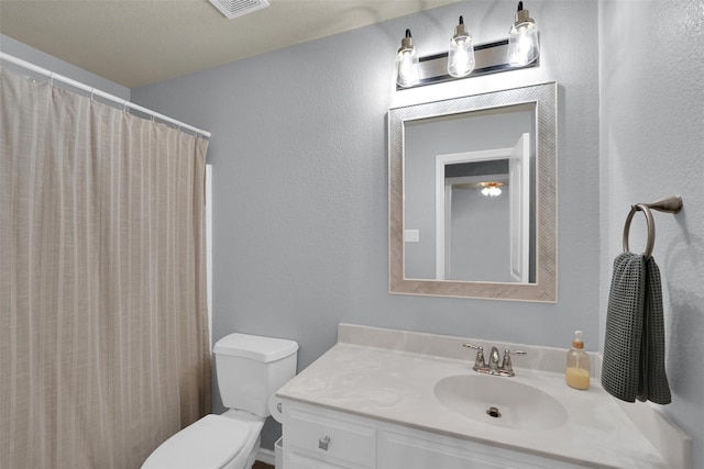 5061 Britton Ridge Ln, Fort Worth, TX 76179 - bathroom with vanity, toilet, and a textured wall