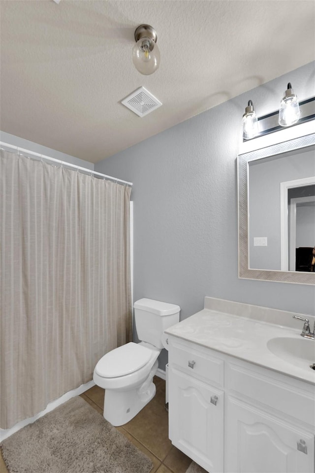 5061 Britton Ridge Ln, Fort Worth, TX 76179 - bathroom featuring vanity, toilet, tile patterned floors, a textured ceiling, and a shower with shower curtain