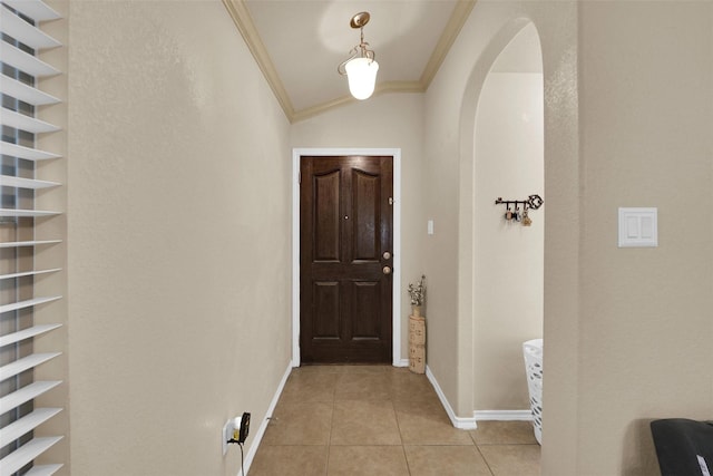 5061 Britton Ridge Ln, Fort Worth, TX 76179 - doorway featuring ornamental molding, light tile patterned floors, baseboards, lofted ceiling, and arched walkways