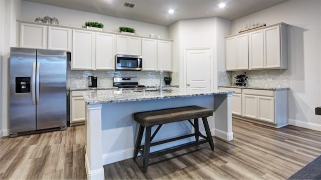 7436 Palisades Dr, Rowlett, TX 75088 - kitchen featuring appliances with stainless steel finishes, a sink, wood finished floors, and recessed lighting