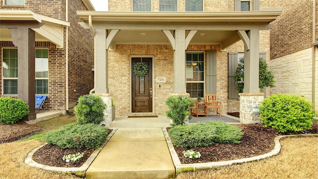 7436 Palisades Dr, Rowlett, TX 75088 - view of exterior entry featuring covered porch and brick siding