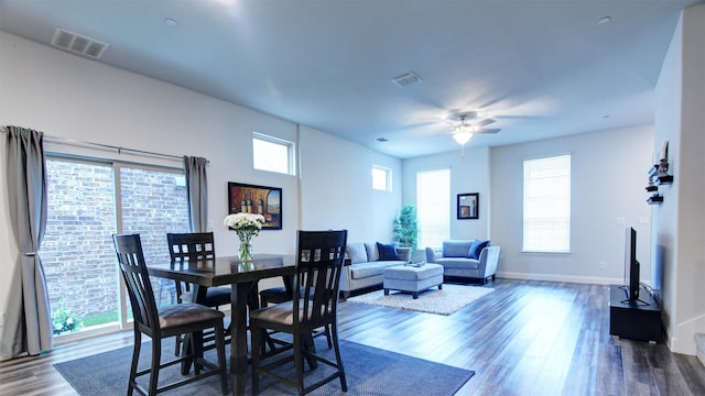7436 Palisades Dr, Rowlett, TX 75088 - dining area featuring dark wood-type flooring, a ceiling fan, and baseboards