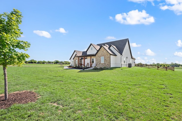 1196 Smith Rd, Ponder, TX 76259 - view of home's exterior with a lawn, central AC unit, and stone siding