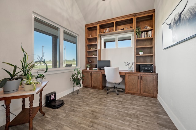 1196 Smith Rd, Ponder, TX 76259 - home office featuring lofted ceiling, wood finished floors, baseboards, built in features, and built in study area