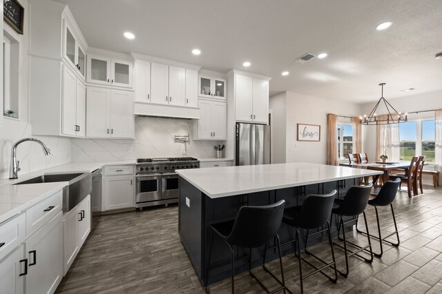 1196 Smith Rd, Ponder, TX 76259 - kitchen featuring appliances with stainless steel finishes, under cabinet range hood, dark wood finished floors, tasteful backsplash, and recessed lighting