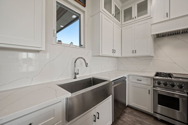 1196 Smith Rd, Ponder, TX 76259 - kitchen with stainless steel appliances, range hood, a sink, white cabinets, and decorative backsplash