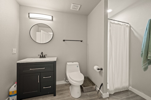 1196 Smith Rd, Ponder, TX 76259 - full bathroom featuring wood finished floors, vanity, toilet, and baseboards