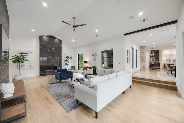 10026 Mccree Rd, Dallas, TX 75238 - living area with light wood-style floors, high vaulted ceiling, a ceiling fan, recessed lighting, and a high end fireplace