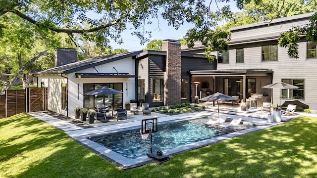 10026 Mccree Rd, Dallas, TX 75238 - rear view of property with a chimney, a patio area, and an outdoor pool