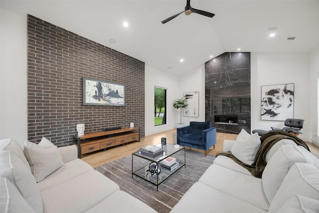 10026 Mccree Rd, Dallas, TX 75238 - living room featuring lofted ceiling, ceiling fan, recessed lighting, wood finished floors, and a high end fireplace