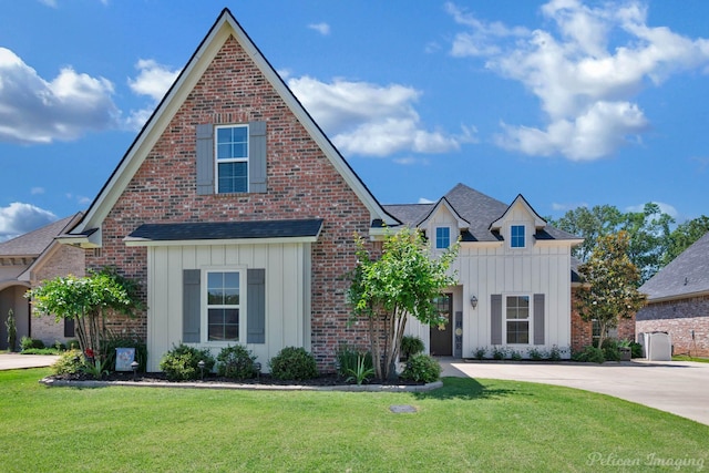 150 St Andrews Ln, Benton, LA 71006 - view of front facade featuring board and batten siding, a front lawn, concrete driveway, and brick siding