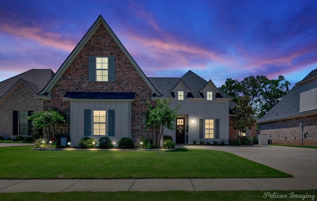 150 St Andrews Ln, Benton, LA 71006 - view of front of home featuring board and batten siding, a front lawn, brick siding, concrete driveway, and roof with shingles