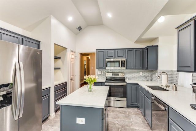 49 Sonora Dr, Trophy Club, TX 76262 - kitchen featuring stainless steel appliances, a sink, gray cabinets, light countertops, and a center island