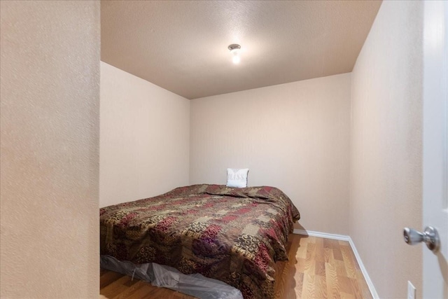 1474 Vz County Road 3810, Wills Point, TX 75169 - bedroom with wood finished floors, a textured ceiling, and baseboards
