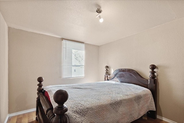 1474 Vz County Road 3810, Wills Point, TX 75169 - bedroom with baseboards, wood finished floors, and a textured ceiling