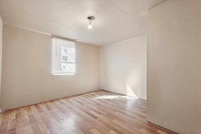 1474 Vz County Road 3810, Wills Point, TX 75169 - spare room with wood finished floors and a textured ceiling