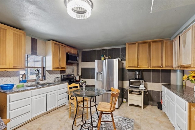 1474 Vz County Road 3810, Wills Point, TX 75169 - kitchen featuring appliances with stainless steel finishes, a sink, decorative backsplash, a textured ceiling, and dark stone counters
