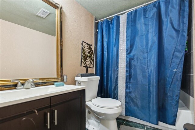 1474 Vz County Road 3810, Wills Point, TX 75169 - bathroom with a textured wall, toilet, vanity, shower / tub combo, and tile patterned flooring
