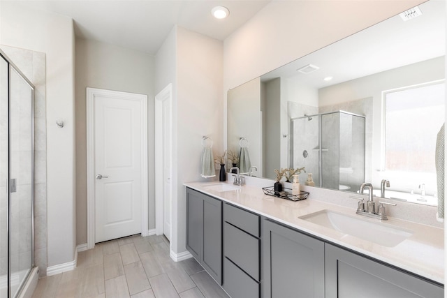 1106 Sassafras Dr, Princeton, TX 75407 - bathroom featuring a shower stall, double vanity, baseboards, and recessed lighting