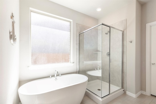 1106 Sassafras Dr, Princeton, TX 75407 - full bath featuring a shower stall, a freestanding tub, tile patterned floors, and baseboards