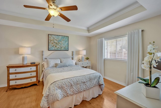 1521 Rice Rd Unit A101, Tyler, TX 75703 - bedroom with crown molding, a raised ceiling, light wood-style floors, baseboards, and a ceiling fan