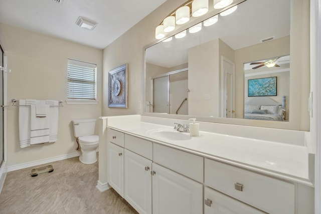 1521 Rice Rd Unit A101, Tyler, TX 75703 - ensuite bathroom featuring baseboards, a stall shower, toilet, and a ceiling fan