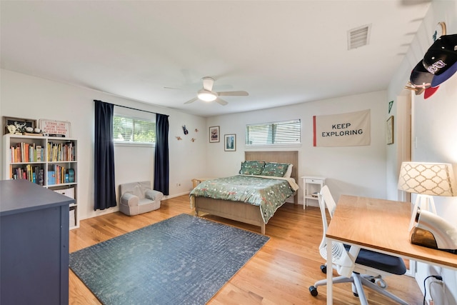 bedroom with wood finished floors, a desk, and ceiling fan