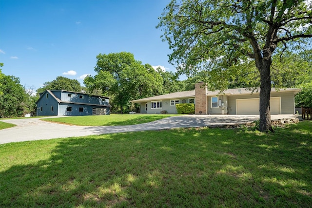 919 Old Justin Rd, Argyle, TX 76226 - view of front of house featuring concrete driveway, a chimney, a front lawn, and an attached garage