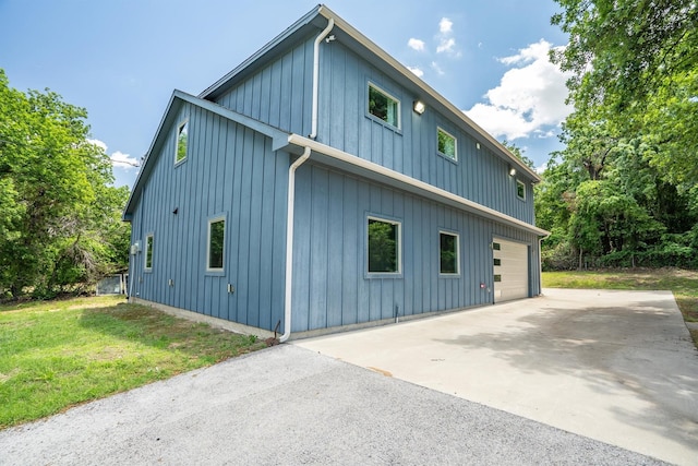 919 Old Justin Rd, Argyle, TX 76226 - view of side of home with an attached garage, board and batten siding, a yard, and driveway