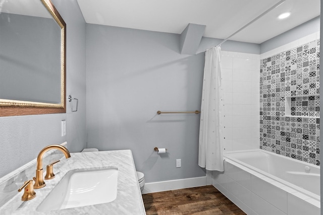 919 Old Justin Rd, Argyle, TX 76226 - bathroom featuring a sink, toilet, wood finished floors, shower / bath combo with shower curtain, and baseboards