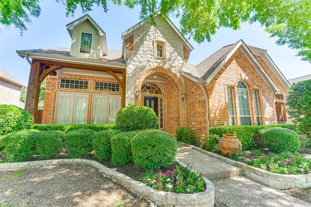 2621 Elmbrook Dr, Carrollton, TX 75010 - view of front of house featuring brick siding and a shingled roof