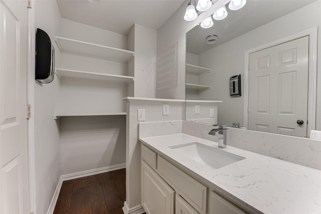 2621 Elmbrook Dr, Carrollton, TX 75010 - bathroom with wood finished floors, vanity, and baseboards