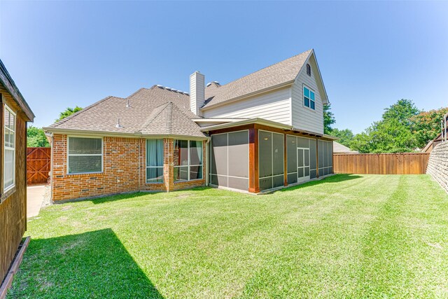 2621 Elmbrook Dr, Carrollton, TX 75010 - back of property featuring a sunroom, a chimney, a shingled roof, and brick siding