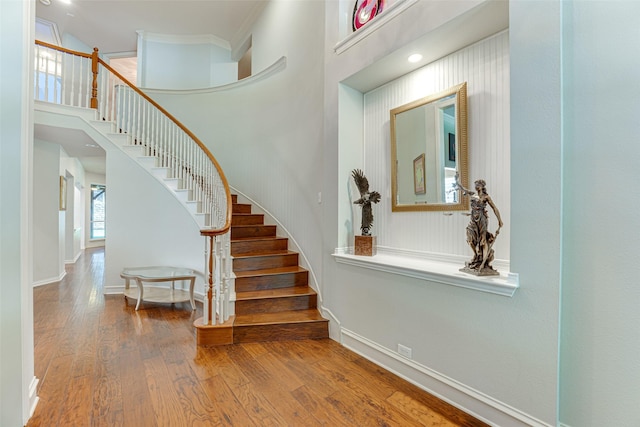 2621 Elmbrook Dr, Carrollton, TX 75010 - staircase with wood finished floors, a high ceiling, and baseboards