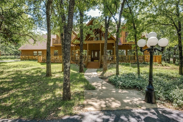 348 Indian Trl, Decatur, TX 76234 - view of front of house featuring board and batten siding, a front lawn, and a porch