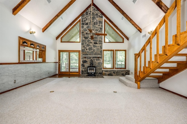 348 Indian Trl, Decatur, TX 76234 - unfurnished living room with high vaulted ceiling, a wood stove, carpet flooring, stairway, and beam ceiling