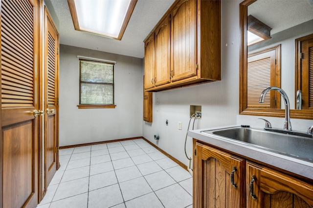 348 Indian Trl, Decatur, TX 76234 - laundry room with cabinet space, electric dryer hookup, hookup for a washing machine, light tile patterned floors, and baseboards