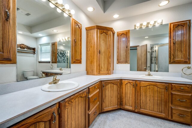 348 Indian Trl, Decatur, TX 76234 - full bathroom featuring a stall shower, recessed lighting, double vanity, and toilet