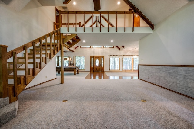 348 Indian Trl, Decatur, TX 76234 - unfurnished living room with high vaulted ceiling, carpet flooring, stairway, and recessed lighting
