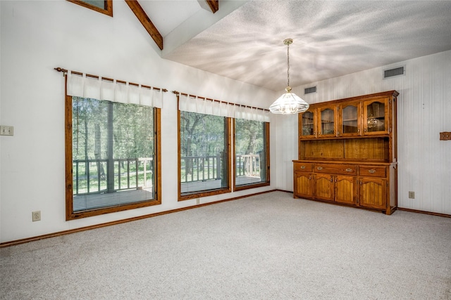 348 Indian Trl, Decatur, TX 76234 - empty room featuring light colored carpet, baseboards, beamed ceiling, a chandelier, and a textured ceiling