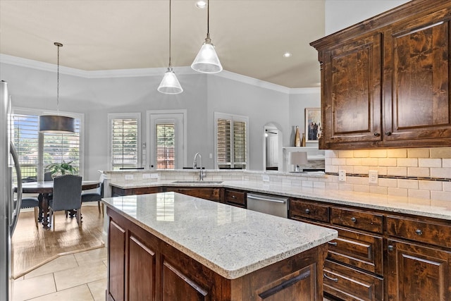kitchen featuring a sink, crown molding, a center island, dishwasher, and light stone countertops