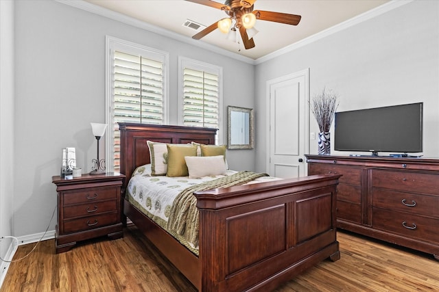 bedroom with dark wood-style flooring, ornamental molding, baseboards, and ceiling fan